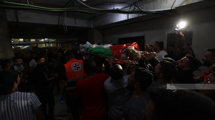 Crowds of people bids farewell for the three victims ahead of leaving them at their final resting place - WAFA